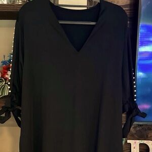 New without tags black dress with splice sleeves lined in pearl buttons. Size 3x